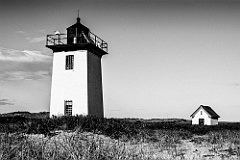 Wood End Light Surrounded by Beach Sand and Grass -BW